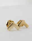 A pair of gold chevron V-shaped stud earrings