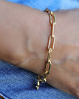 A gold chain bracelet with a simple, linked design.