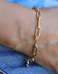 A gold chain bracelet with a simple, linked design.