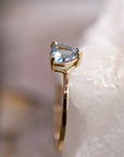 A gold ring with a light blue gemstone. The gemstone is a heart shape and is set in a prong setting. The ring is on a white background. March Birthstone Jewelry, Aquamarine Engagement Ring, Heart Cut Promise Ring Handmade Fine Jewelry, Wedding Jewelry