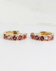 Gold hoop earrings with a row of pink tourmaline gemstones.