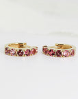Gold hoop earrings with a row of pink tourmaline gemstones.