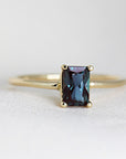 An alexandrite ring in 14K gold, handmade jewelry with a dark blue, emerald-cut alexandrite gemstone
