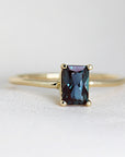 An alexandrite ring in 14K gold, handmade jewelry with a dark blue, emerald-cut alexandrite gemstone