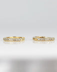 A pair of gold hoop earrings with a single row of small diamonds around the edge.