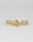A gold ring with a chain design and a square-shaped paved diamonds in the center.