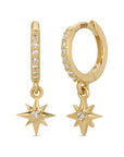 A pair of 14k gold hoop earrings with a dangling star charm. Each hoop is lined with small diamond stones and has a small clear diamond stone in the center of the star charm.