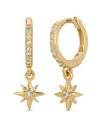 A pair of 14k gold hoop earrings with a dangling star charm. Each hoop is lined with small diamond stones and has a small clear diamond stone in the center of the star charm.