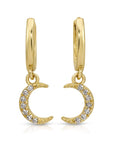 Close-up of crescent moon dangle earrings with 14 diamonds set in gold, photographed hanging with soft light to show sparkle and detail.