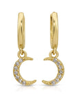Close-up of crescent moon dangle earrings with 14 diamonds set in gold, photographed hanging with soft light to show sparkle and detail.