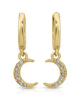 Close-up of crescent moon dangle earrings with 14 diamonds set in gold, photographed hanging with soft light to show sparkle and detail.