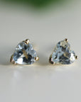 Heart Aquamarine Earrings 14k Solid Gold. A pair of gold heart-shaped earrings with light blue aquamarine gemstones.