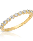 Single prong diamond eternity band in 14k solid gold with floating diamond design, displayed on a white background as a minimalist wedding ring.