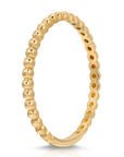 A gold beaded ring with a smooth, polished finish. The ring is made of a single band of metal with a row of small, round beads.