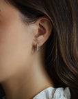 Model wearing 14k Gold Pave Diamond U Earrings