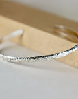 A sterling silver bangle bracelet with a floral design. The bracelet is thin and delicate, and the floral design is intricate and detailed. Personalized Open Cuff Bracelet, Leaf & Flowers Silver Bangle Bracelet Handwriting Inside, Custom Engraved Silver Bracelet, Bridesmaid Gift