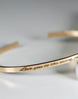 Gold filled open cuff bracelet with custom engraving in handwriting, displayed on a white background to show curved shape and engraving placement.