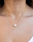 Model wearing a pearl necklace with gold filled chain