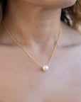 Model wearing a pearl necklace with gold filled chain