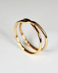 Gold X ring with hammered texture, criss cross wrap design, gold filled handmade ring styled on a white background, minimalist stacking jewelry