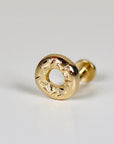 Gold-toned donut-shaped earring with a textured surface. The earring is a stud style with a post and a back.