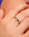 A gold ring with a single montana sapphire set in a v-shaped band.