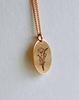 Birth Flower Necklace Gold Filled, A gold chain necklace with an oval pendant featuring a line drawing of a bouquet of flowers.