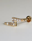 Gold lightning bolt stud earring with clear cubic zirconia stones.