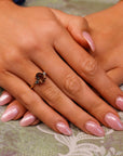 Model wearing an Oval Smokey Quartz Engagement Ring with Green Sapphire Accents