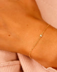 A delicate gold chain bracelet with a single small diamond accent.