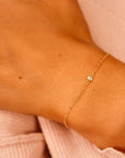 A delicate gold chain bracelet with a single small diamond accent.