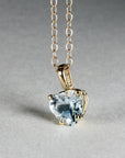 Heart-shaped aquamarine pendant necklace in 14k solid gold displayed on a model’s neck, dainty March birthstone jewelry, perfect gift for her.