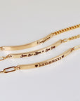 Gold filled personalized bar bracelet with custom engraving, dainty nameplate bracelet styled on a neutral background, minimalist gift for her
