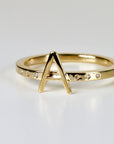 Bold 14k gold initial ring with a modern square band and six scattered diamonds, featuring an 8mm letter on top, shown on white background.