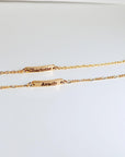 Custom gold filled bar bracelet with a child’s name engraved, shown on a white background. Dainty and personalized baby jewelry.