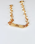 Custom gold filled bar bracelet with a child’s name engraved, shown on a white background. Dainty and personalized baby jewelry.