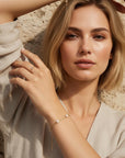Model wearing dainty gold filled pearl chain bracelet with freshwater pearl, minimalist bridal jewelry