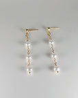 Close up of freshwater pearl drop earrings with zircon stud and gold filled chain