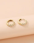 Side view of chunky diamond huggie hoop earrings showing hinged closure in 14k gold
