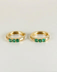 Emerald huggie hoop earrings in 14k gold with three 2mm lab grown emerald stones