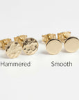 Flat lay of two pairs of tiny gold filled circle stud earrings, one pair hammered texture and one smooth finish, minimalist 5mm disc studs