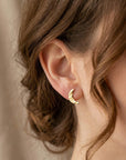 14k solid gold crescent moon stud earrings worn on ear, minimalist celestial everyday jewelry