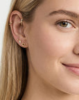 14k solid gold donut flat back earring worn in cartilage piercing, cute food themed minimalist stud