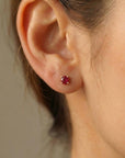 14k solid gold ruby stud earrings worn on ear, delicate natural red gemstone jewelry for everyday wear