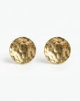 Hammered gold filled circle stud earrings in flat lay, minimalist round disc posts, close-up product photo