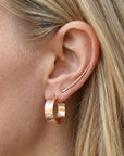 Wide hammered gold hoop earrings worn on ear, thick handmade gold filled hoop earrings for everyday wear