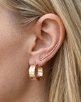 Wide hammered gold hoop earrings worn on ear, thick handmade gold filled hoop earrings for everyday wear