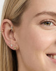 14k solid gold tiny pizza slice flat back earring worn in tragus piercing, cute food themed ear stack stud with CZ diamond