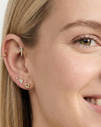 14k solid gold tiny pizza slice flat back earring worn in tragus piercing, cute food themed ear stack stud with CZ diamond