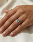 March birthstone aquamarine engagement ring in prong setting on hand